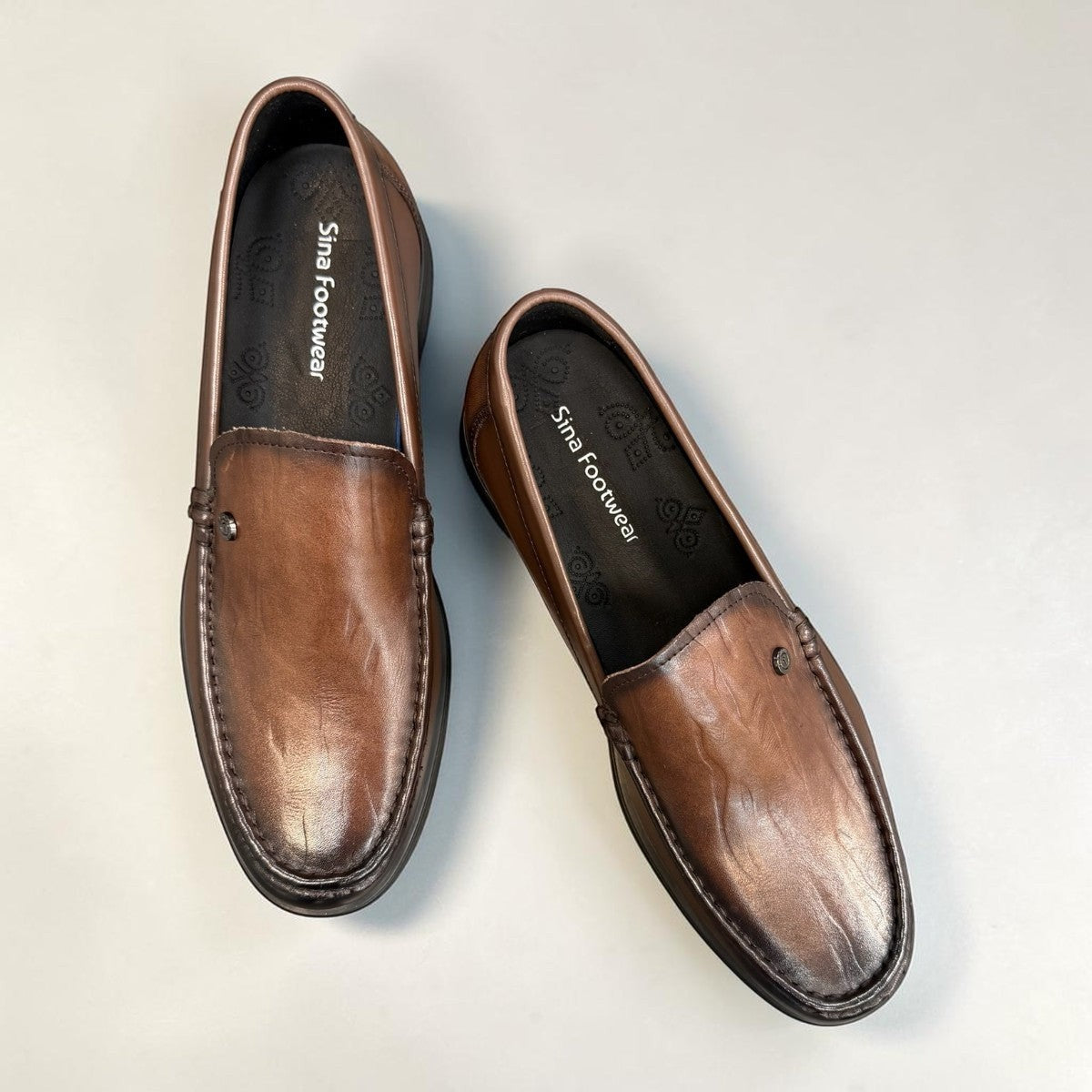 Sina Footwear dark brown genuine leather loafer with a classic slip-on design and durable rubber outsole.
photo of the top side