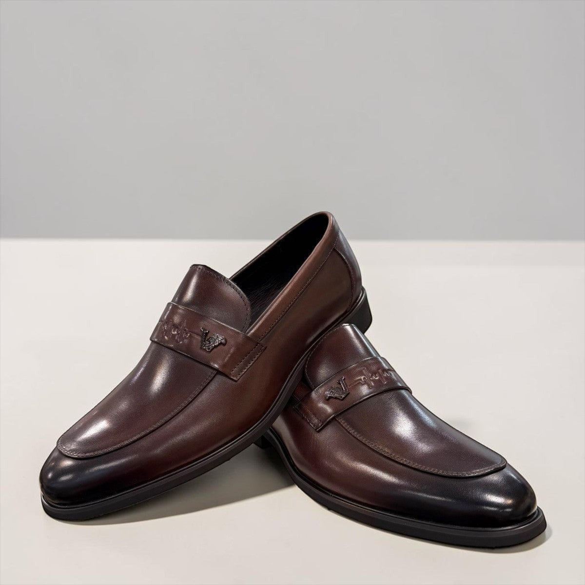 Sina Footwear dark brown genuine leather loafer with a classic silhouette, metal detail, and durable rubber outsole.
photo of the front side