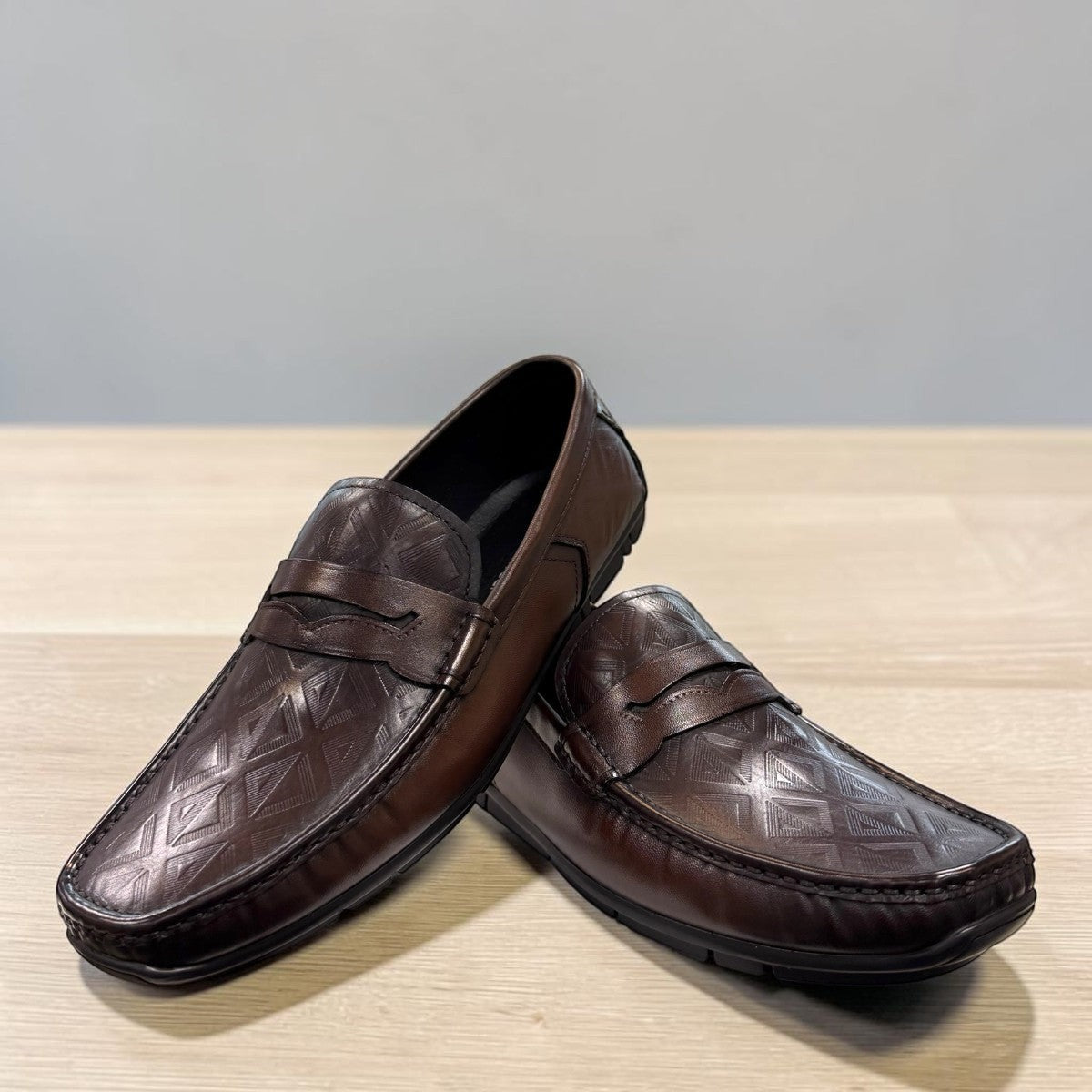 Sina Footwear dark brown genuine leather loafer with embossed geometric pattern and durable rubber outsole.
photo of the front side