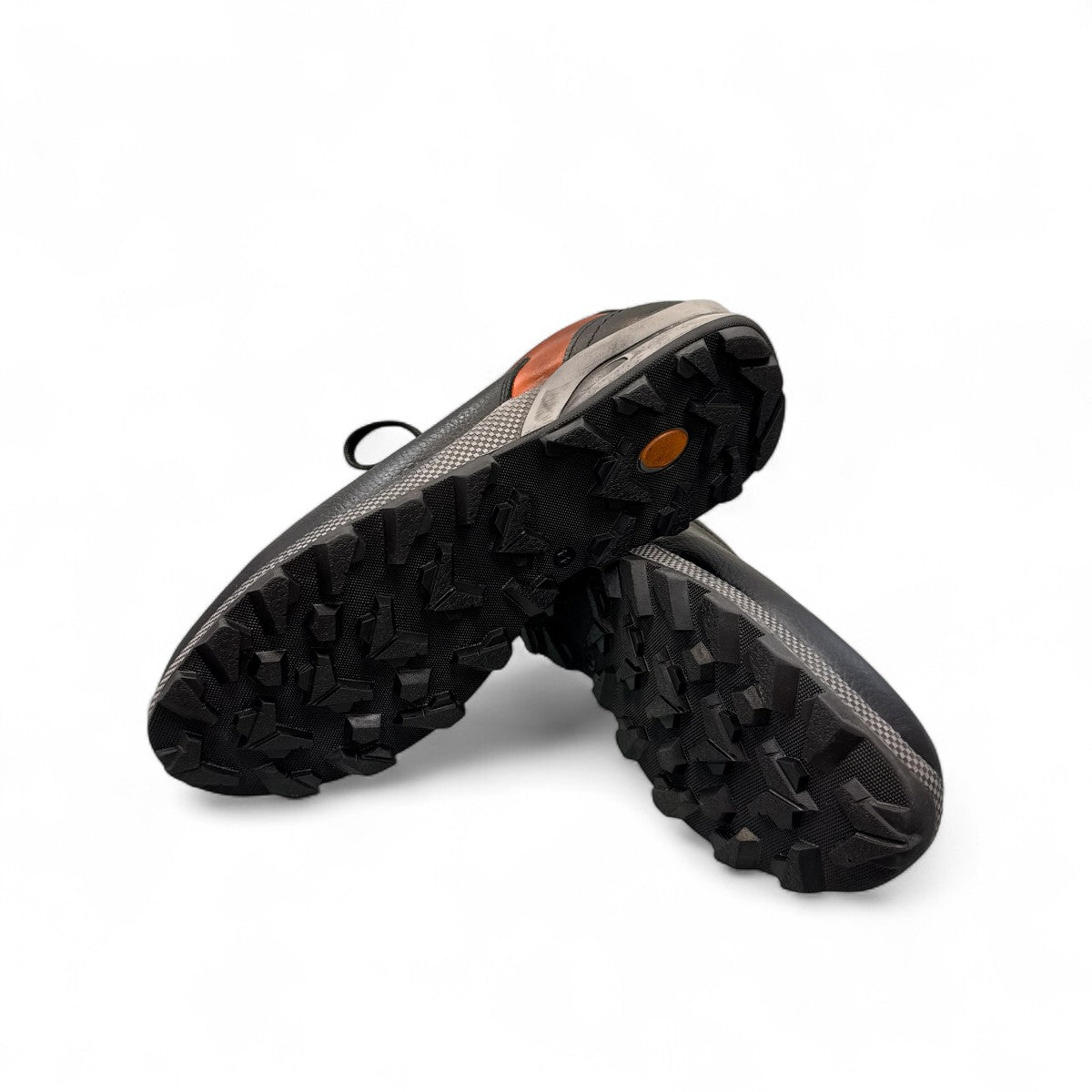 Sina Footwear Gilan black leather lace-up shoe with brown heel detail, textured rubber outsole, and side stitching. Photo of bottom view.