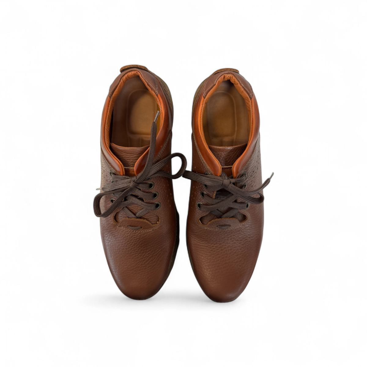 Sina Footwear Gilan brown leather lace-up shoe with textured upper, handmade stitching, and durable rubber sole. Photo of the soles.