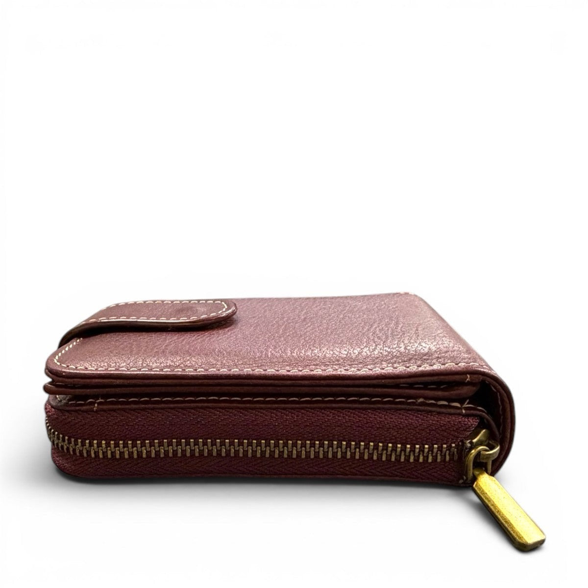 Sina Footwear genuine leather wallet in a dusty rose color with a zip closure and snap button.