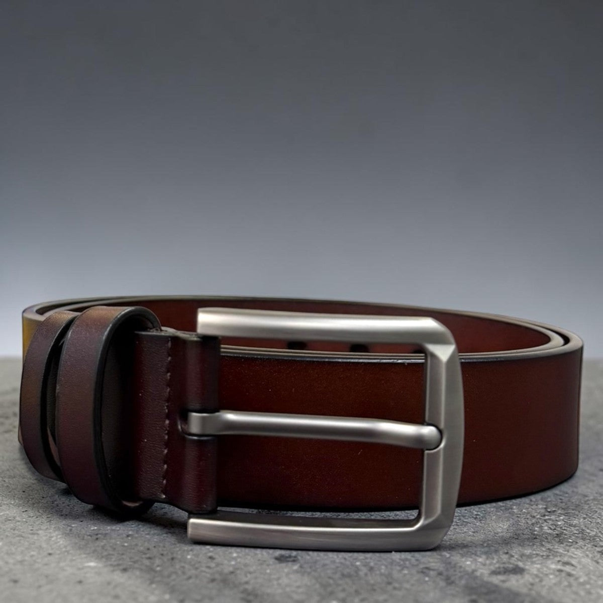 Sina Footwear men's dark brown genuine leather belt with a sleek silver buckle. Smooth finish, perfect for formal or everyday wear.