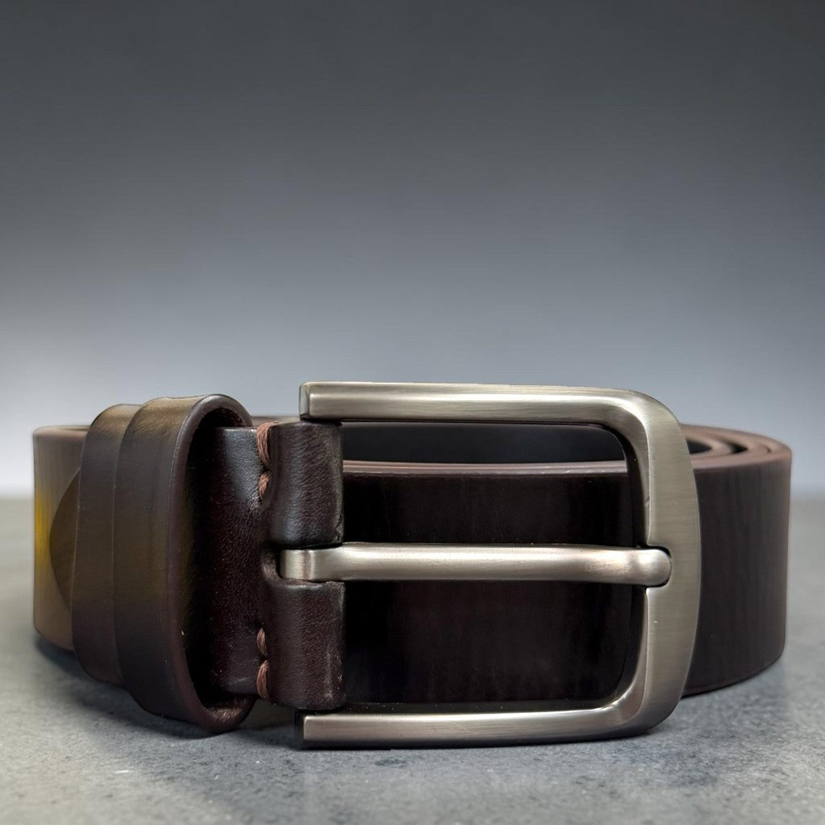 Sina Footwear men's dark brown genuine leather belt with a sleek silver buckle. Smooth finish, perfect for formal or everyday wear.