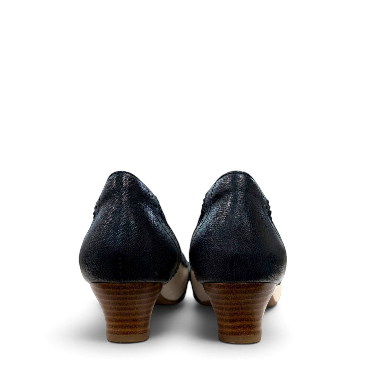 Sina Footwear navy blue and off-white leather pumps with brogue detailing, pointed toe, and low block heel.
photo of the back side