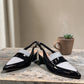 Django & Juliette navy patent leather slingback loafers with a 2-inch block heel and adjustable strap.
front view.