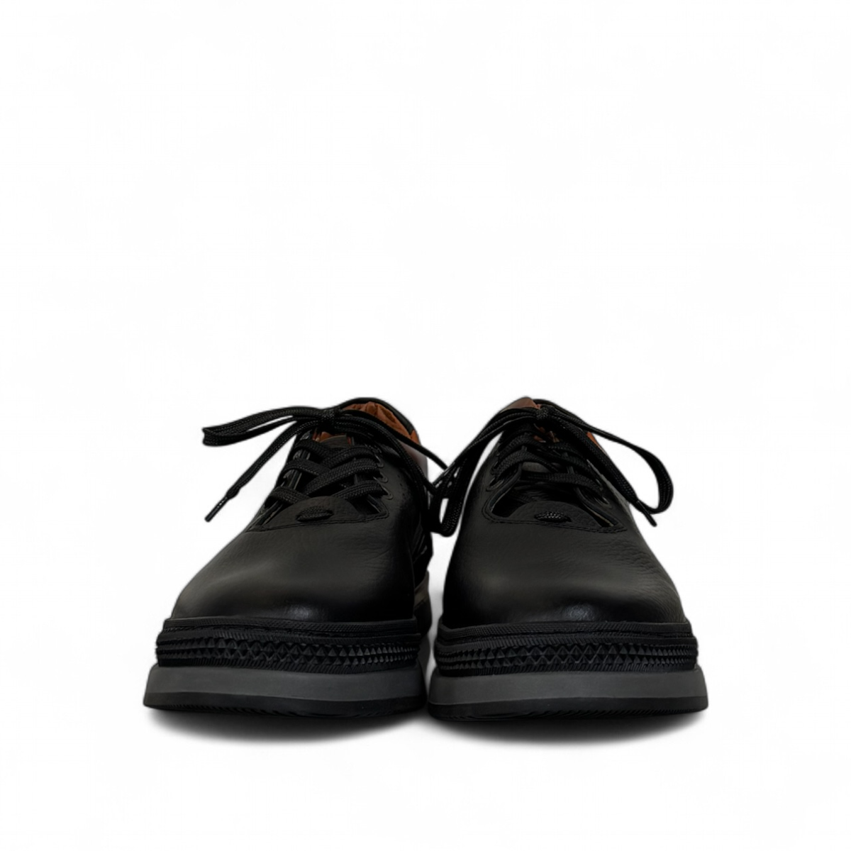 Sina Footwear Pasargad black leather lace-up sneakers with brown accents and a durable rubber outsole. Photo of front view.