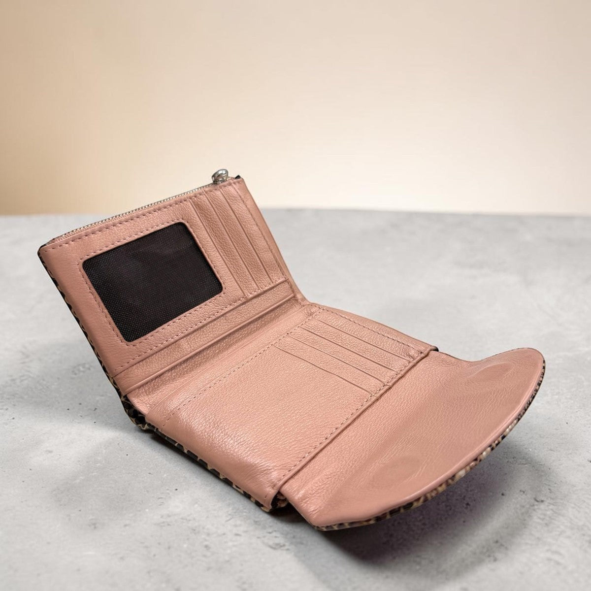 Sina Footwear pink textured leather bifold wallet with money clip and ID window.