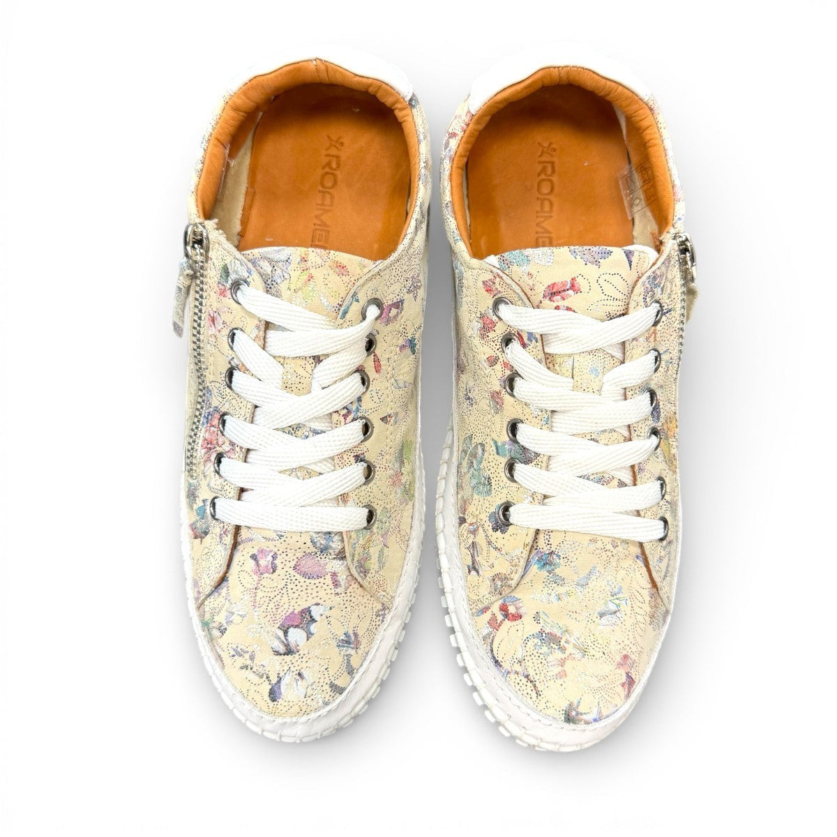 Roamers Audrey taupe leather sneaker with floral pattern, side zipper, and white rubber outsole.
photo of the top side