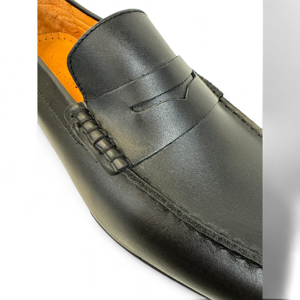 Sina Footwear Samin black genuine leather loafers with subtle handmade stitching for formal or smart casual wear. Photo close up.
