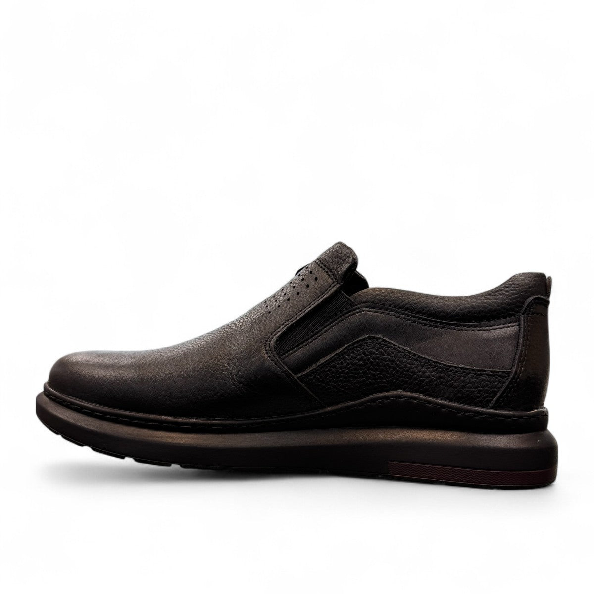 Sina Footwear Satel black genuine leather slip-on shoe with textured upper, rubber outsole, and handmade stitching. Photo of left side view.