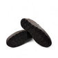 Sina Footwear Satel black genuine leather slip-on shoe with textured upper, rubber outsole, and handmade stitching. Photo of bottom view.