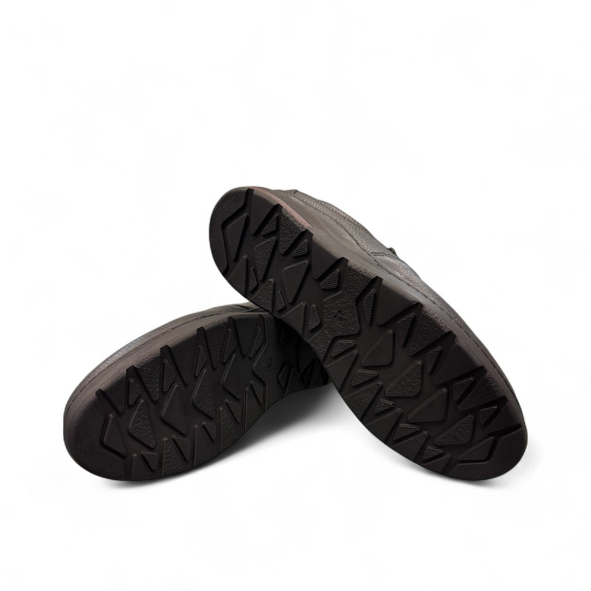 Sina Footwear Satel black genuine leather slip-on shoe with textured upper, rubber outsole, and handmade stitching. Photo of bottom view.