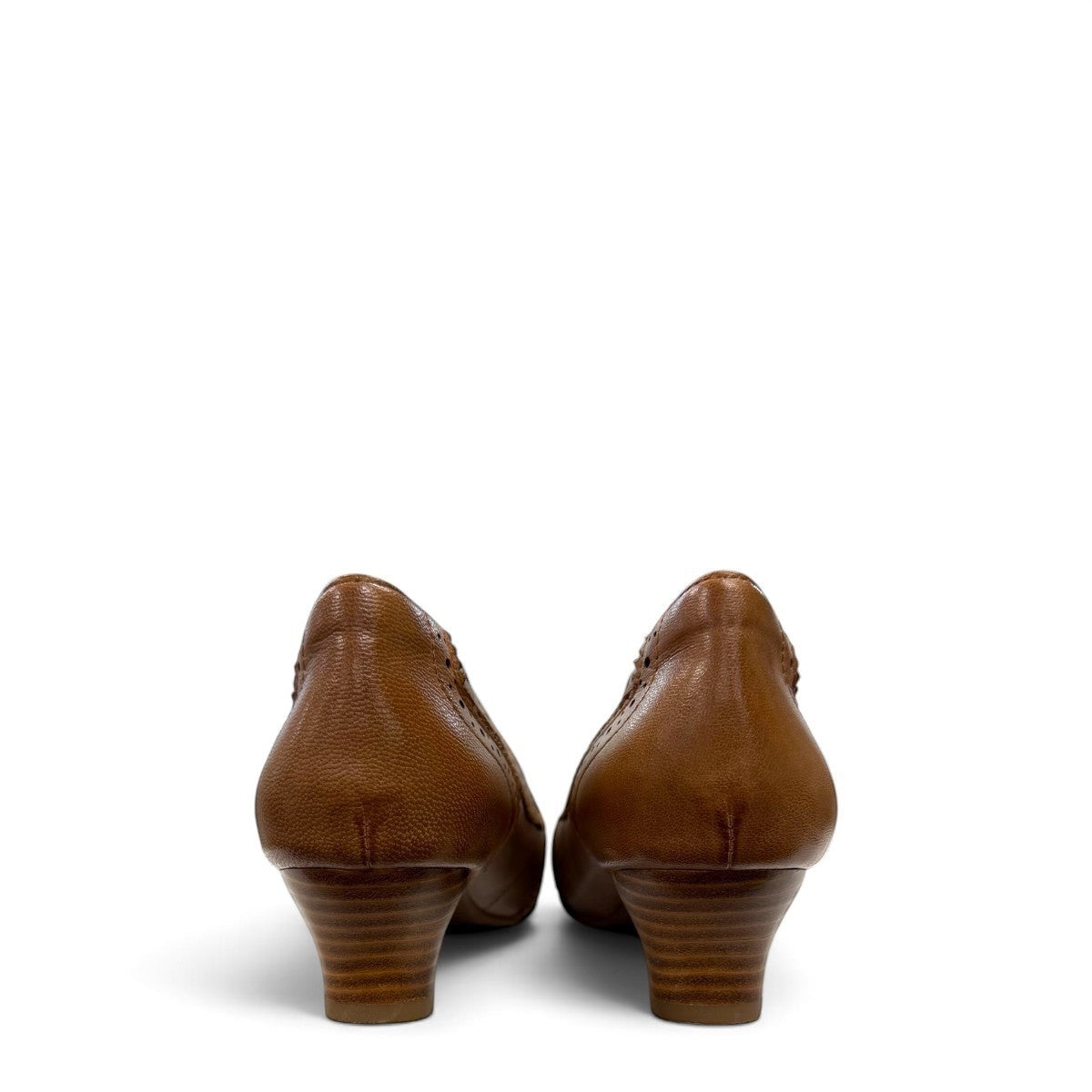 Sina Footwear tan leather pump with pointed toe, brogue-inspired perforated details, and a low block heel.
photo of the back side