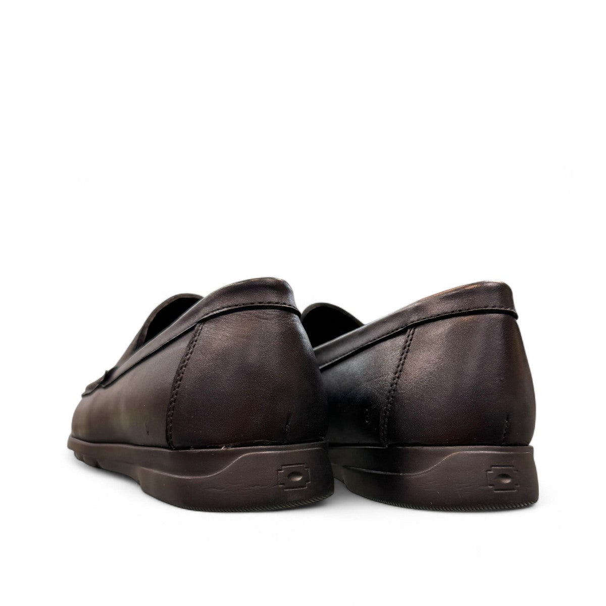 Sina Footwear Vanak black leather loafers with handmade stitching and a durable rubber outsole for formal wear. Photo of back views.