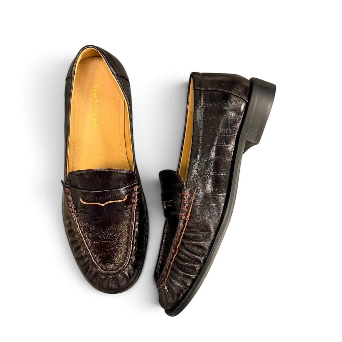 Sina Footwear wine-colored genuine leather loafer with hand-finished gathered detailing and a durable rubber outsole.
photo of the top side