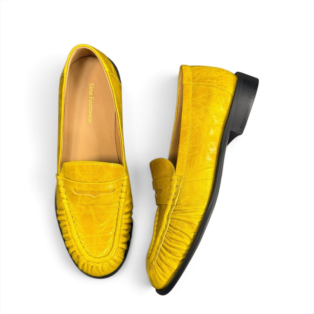 Sina Footwear yellow genuine leather loafer with hand-finished gathered detailing and a durable rubber outsole.
photo of the top side