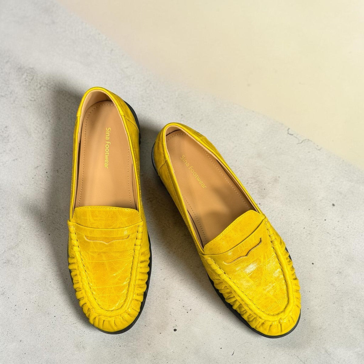 Sina Footwear yellow genuine leather loafer with hand-finished gathered detailing and a durable rubber outsole.
photo of the top side