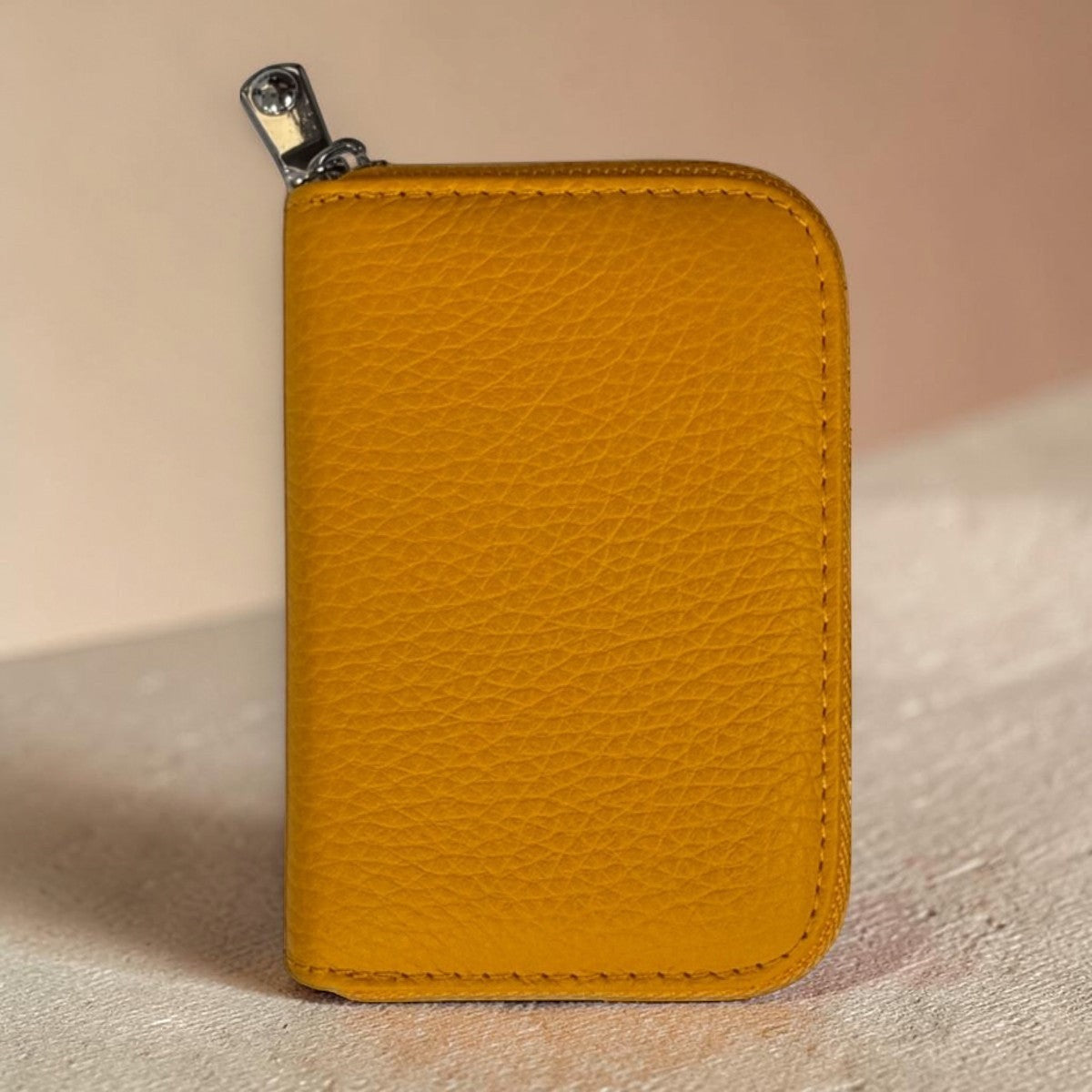 Sina Footwear yellow genuine leather bifold wallet with zipper closure and inner compartments.
