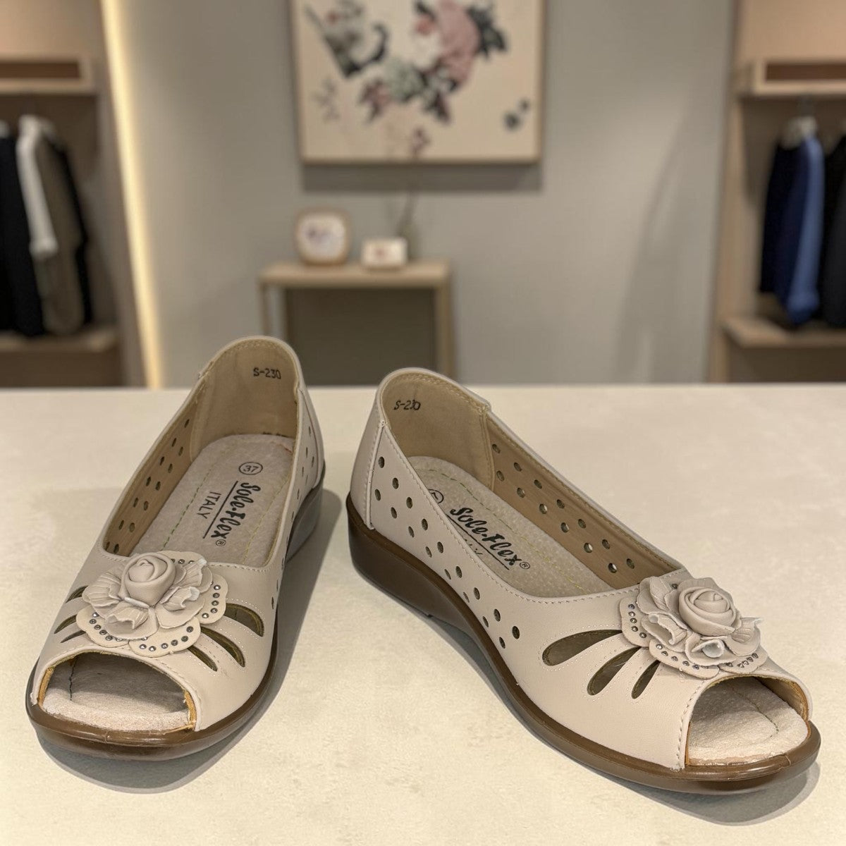 soflex-S230 beige peep-toe comfort flats with floral detail and breathable side perforations on a low wedge sole.
photo of the top side