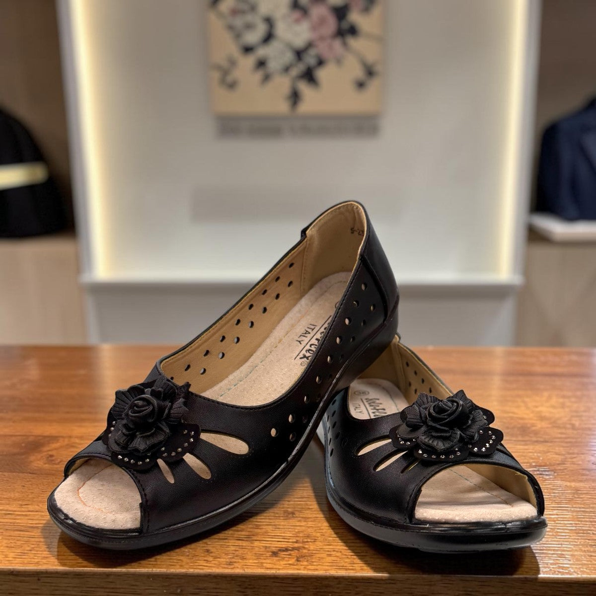 soflex-S230 black peep-toe comfort flats with floral detail, side perforations, and a flexible low-profile sole.
photo of the front side