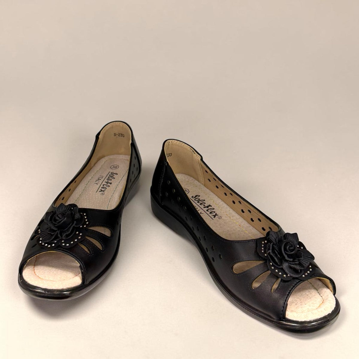 soflex-S230 black peep-toe comfort flats with floral detail, side perforations, and a flexible low-profile sole.
photo of the front side