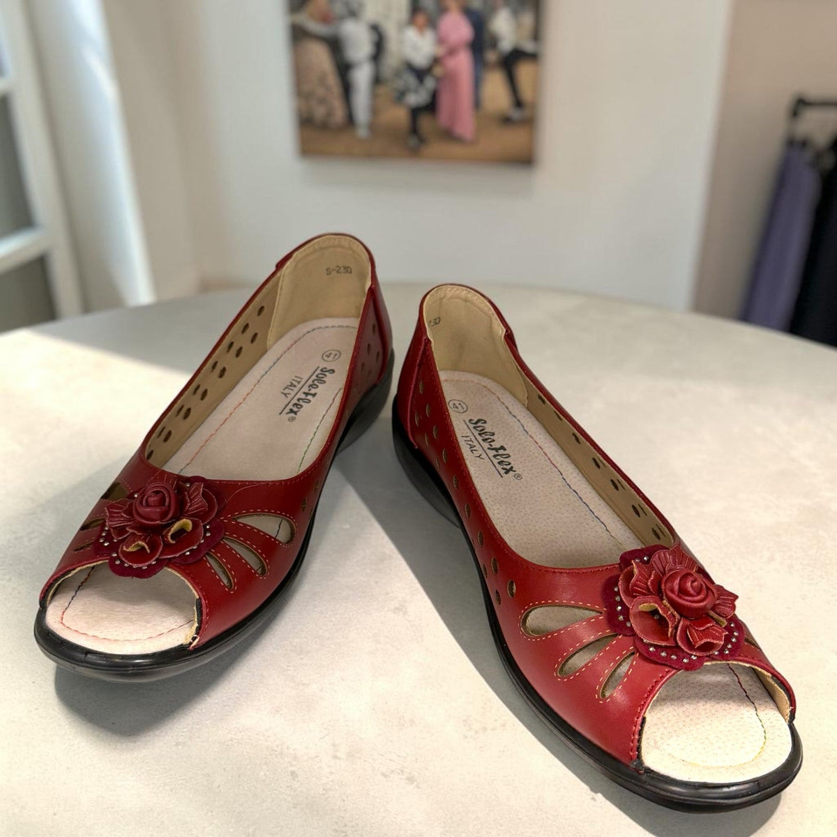 soflex-S230 red peep-toe comfort flats with floral detail, side perforations, and a flexible low-profile sole.
photo of the front side