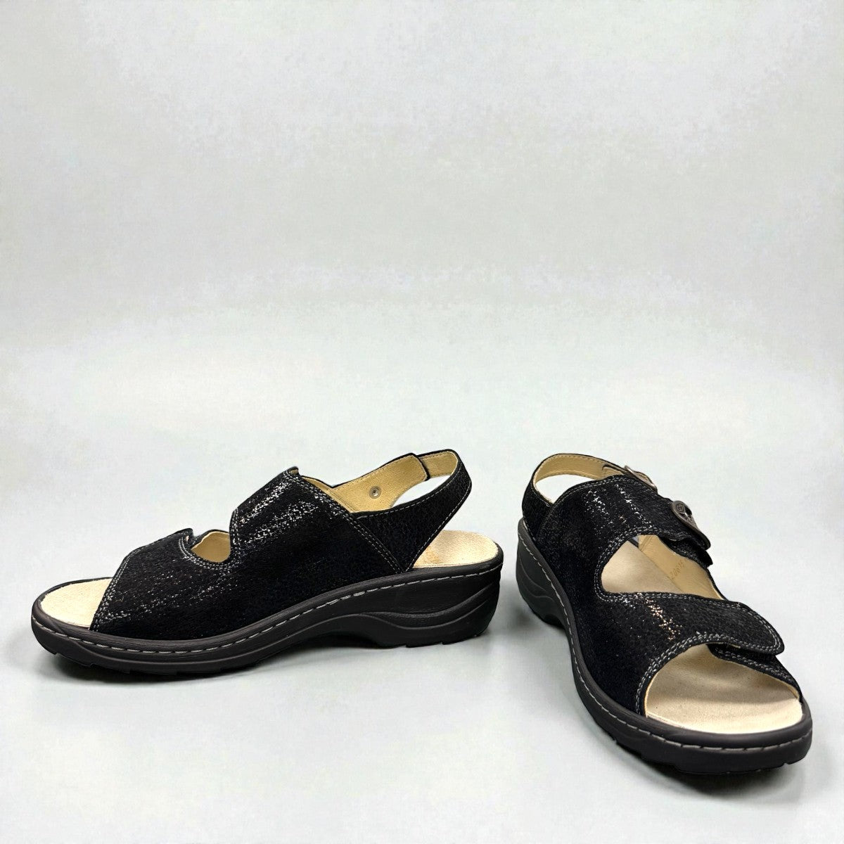 softline black leather Hedi wedge sandals with shiny finish, adjustable velcro straps, and decorative buckle.
photo of the front side