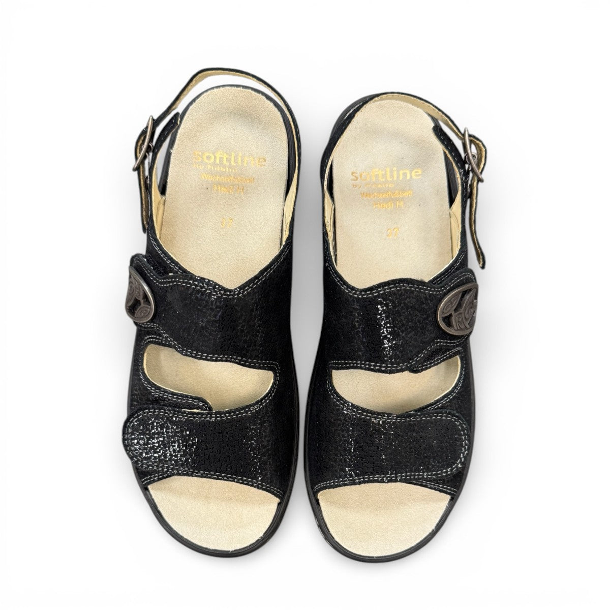 softline black leather Hedi wedge sandals with shiny finish, adjustable velcro straps, and decorative buckle.
photo of the top side
