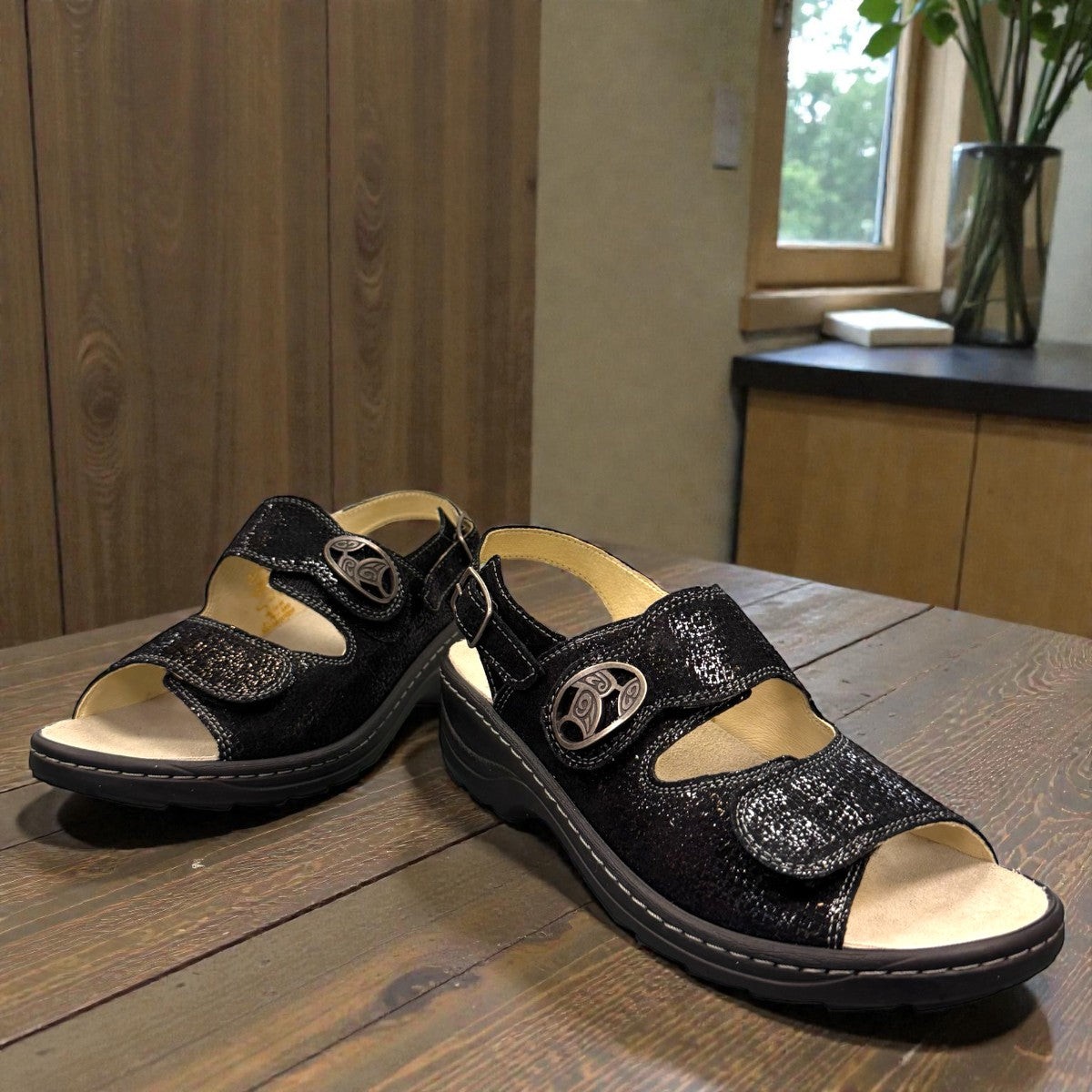 softline black leather Hedi wedge sandals with shiny finish, adjustable velcro straps, and decorative buckle.
photo of the front side