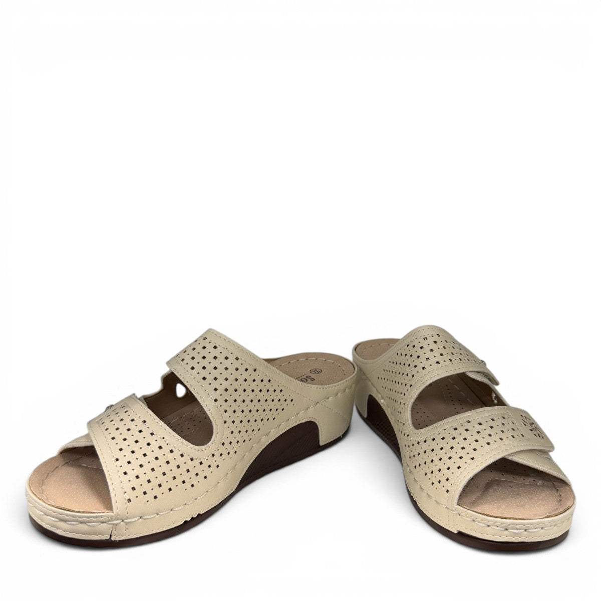 sole-flex-S1110 beige comfort slide sandals with adjustable straps, cut-out floral details, and a low wedge platform.
photo of the front side