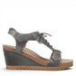 Taos Tie Wish steel grey leather wedge sandal with T-strap, lace-up detail, and cork-style midsole. Photo of outside side view.