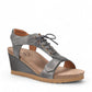 Taos Tie Wish steel grey leather wedge sandal with T-strap, lace-up detail, and cork-style midsole. Photo of front view.