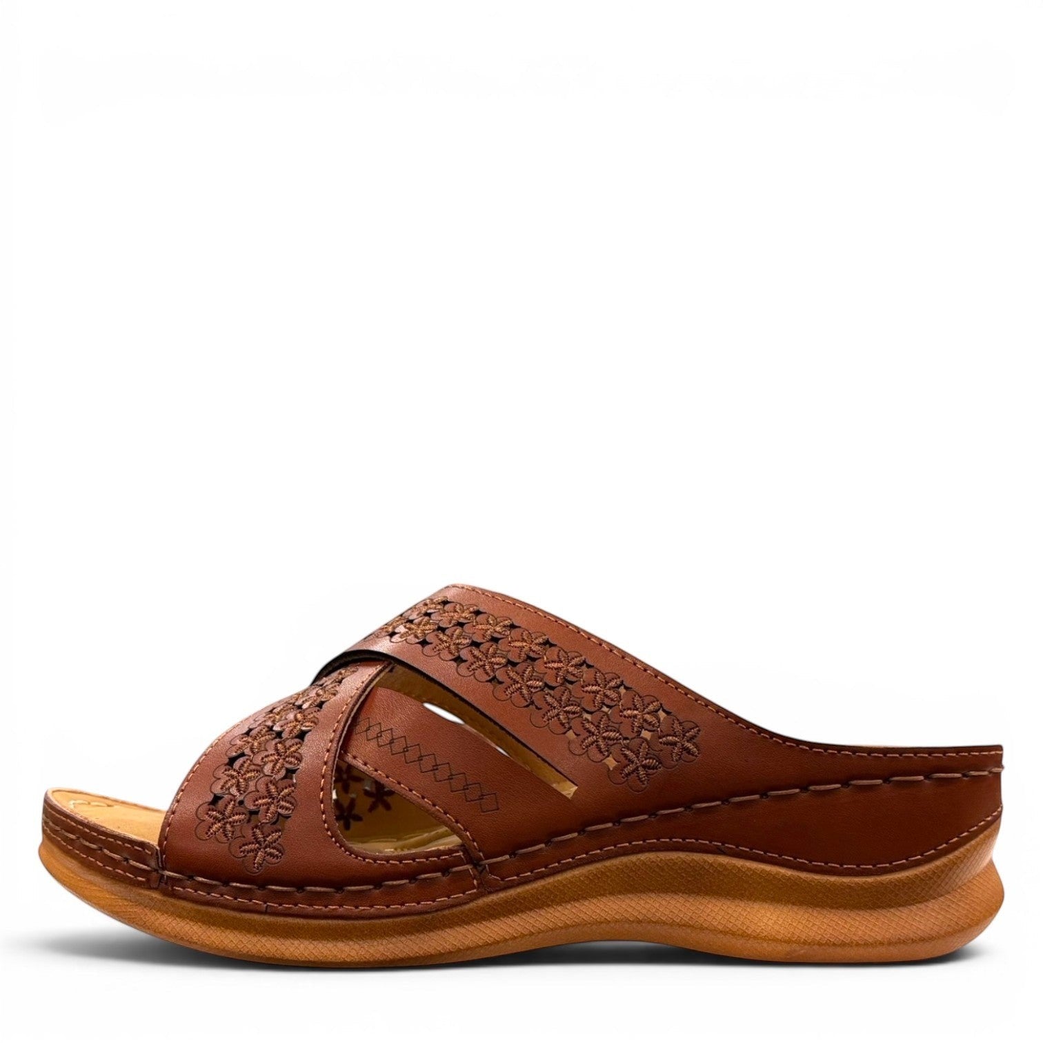 stefania camel vegan leather slide sandal with floral laser-cut details and a comfortable cushioned sole.
photo of the left side