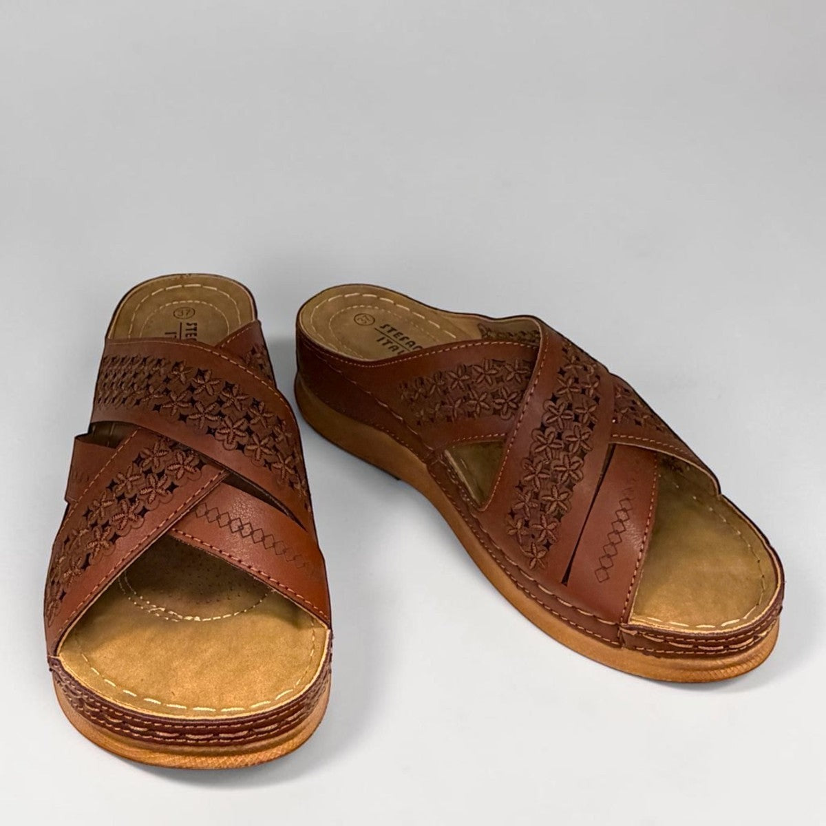stefania camel vegan leather slide sandal with floral laser-cut details and a comfortable cushioned sole.
photo of the front side