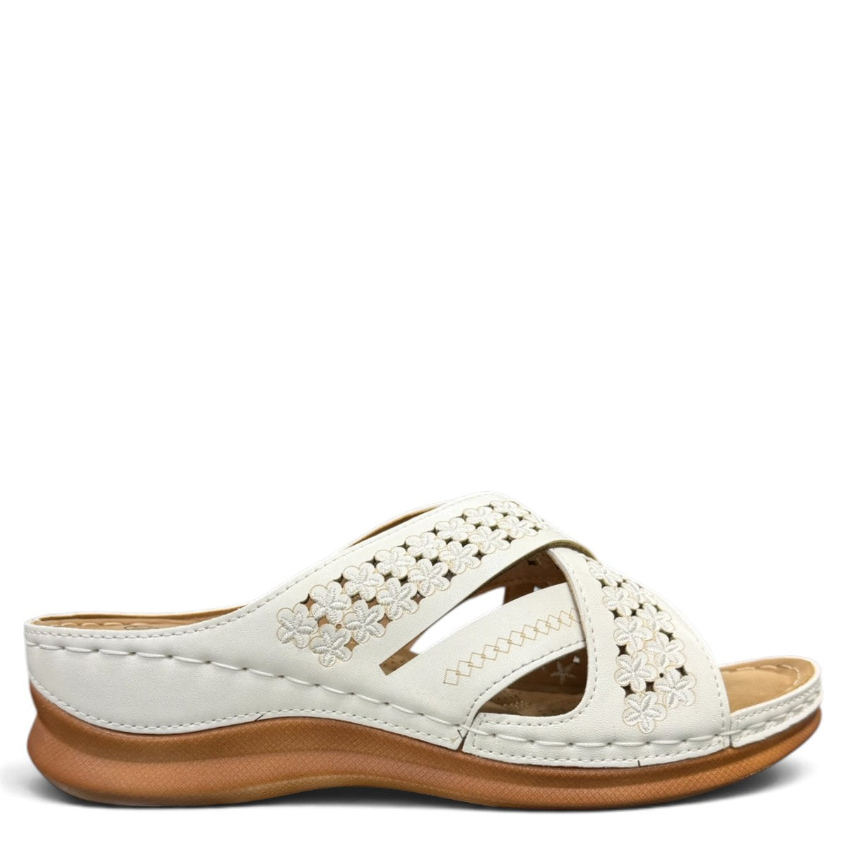 stefania S20215 white vegan leather slide sandals with floral cut-out details and a comfortable brown wedge sole.
 photo of the right side