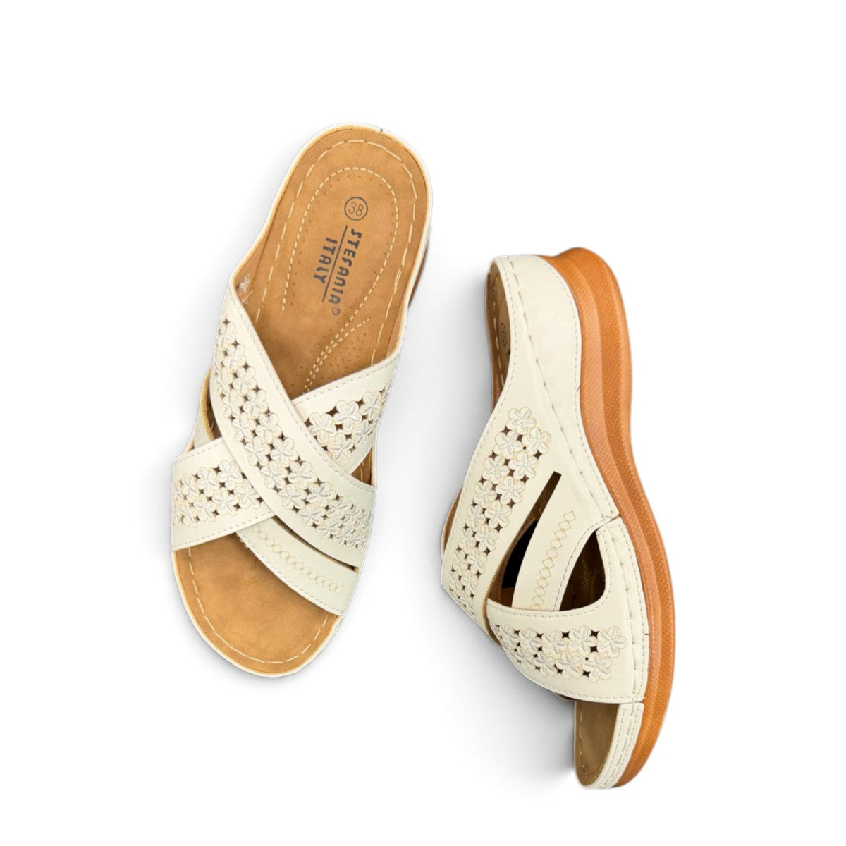 stefania S20215 white vegan leather slide sandals with floral cut-out details and a comfortable brown wedge sole.
 photo of the top side