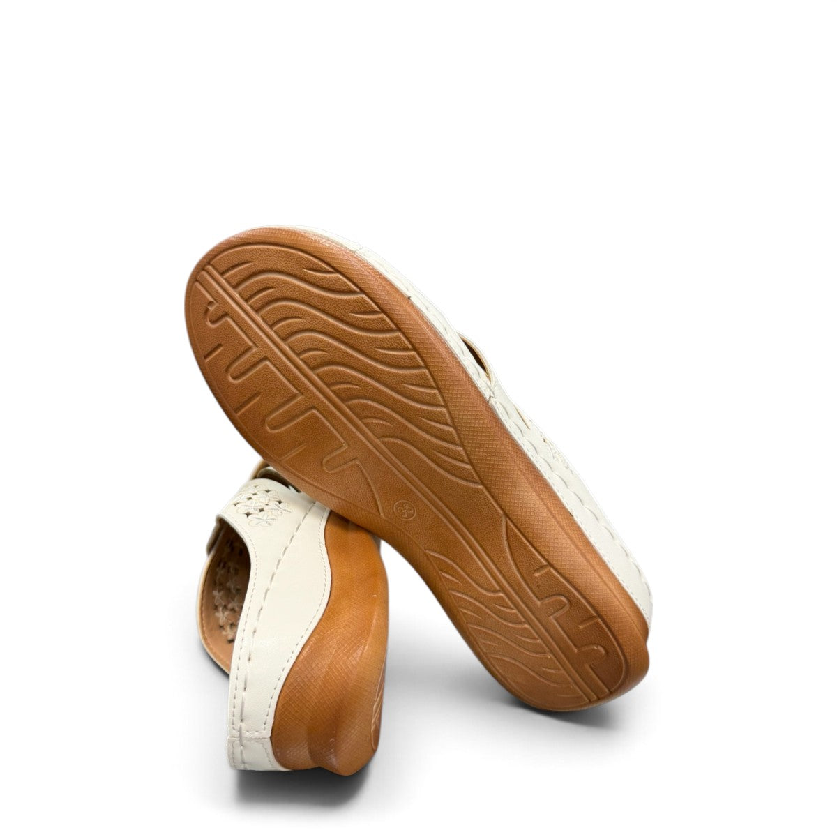 stefania S20215 white vegan leather slide sandals with floral cut-out details and a comfortable brown wedge sole.
 photo of the bottom side