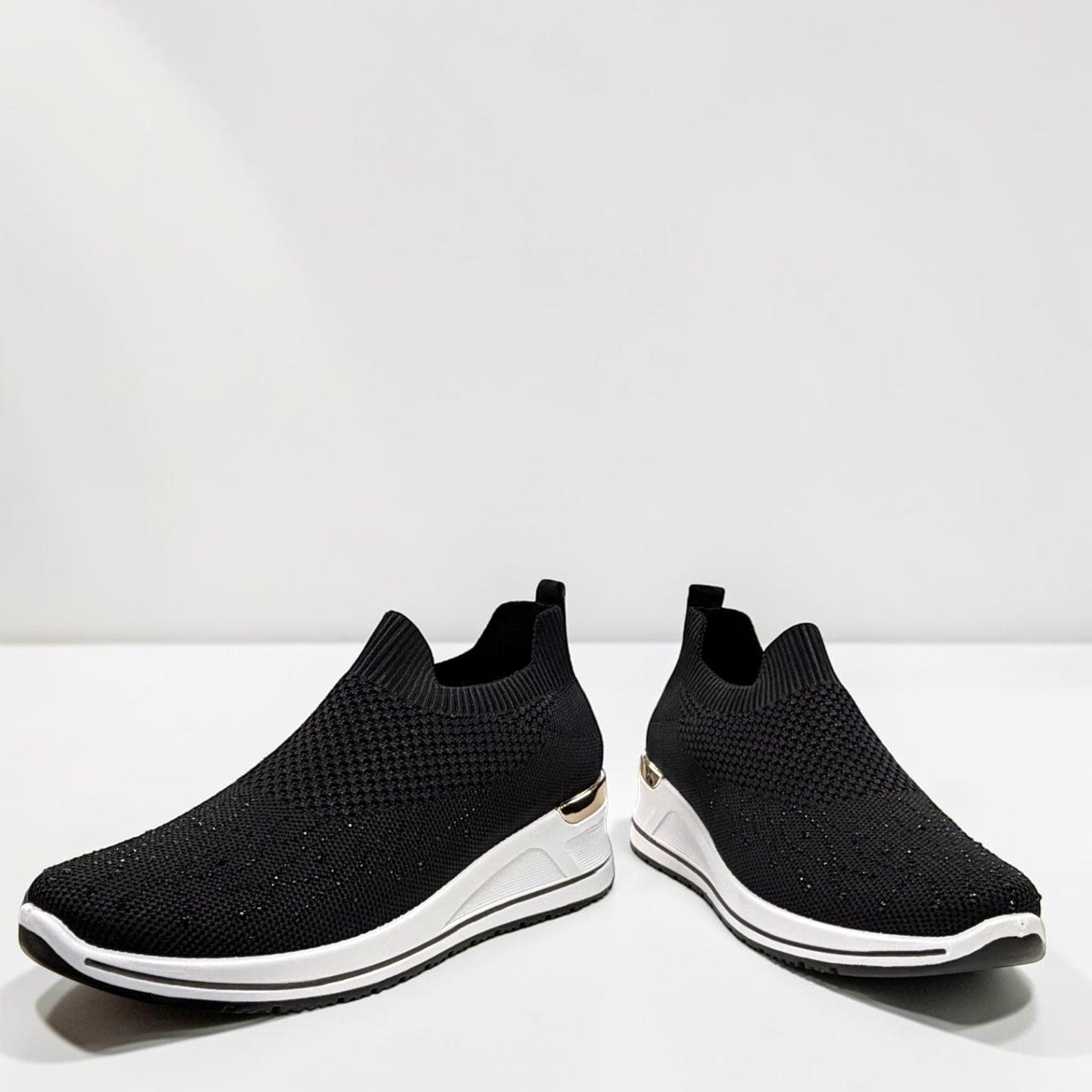 STEFANIA S4000 black slip-on knit platform sneakers with a white wedge sole and subtle shimmer details.
photo of the front side