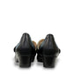 stefania aria black Mary Jane shoe with decorative laser-cut perforations, dual straps, and a stable block heel.
photo of the back side