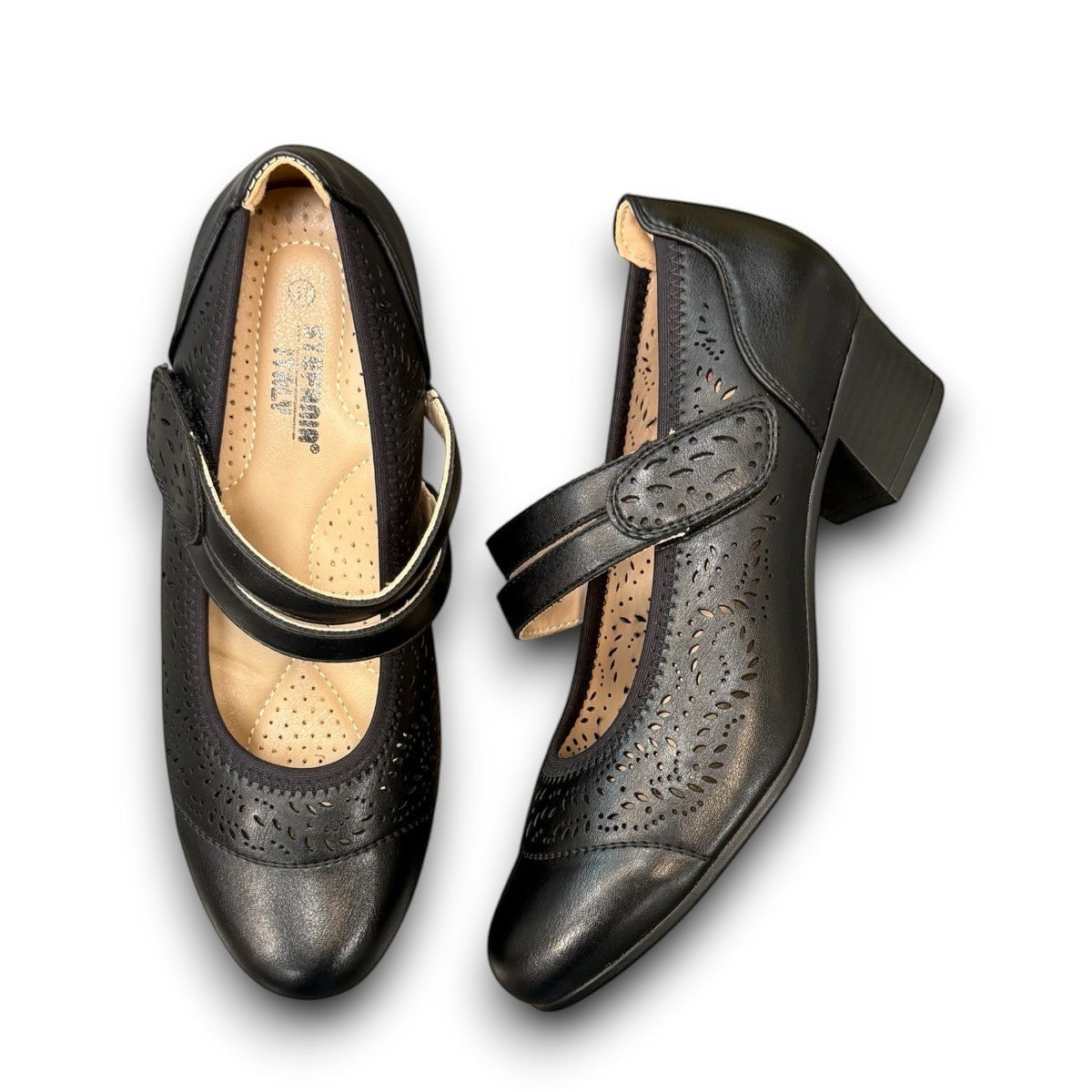 stefania aria black Mary Jane shoe with decorative laser-cut perforations, dual straps, and a stable block heel.
photo of the top siide