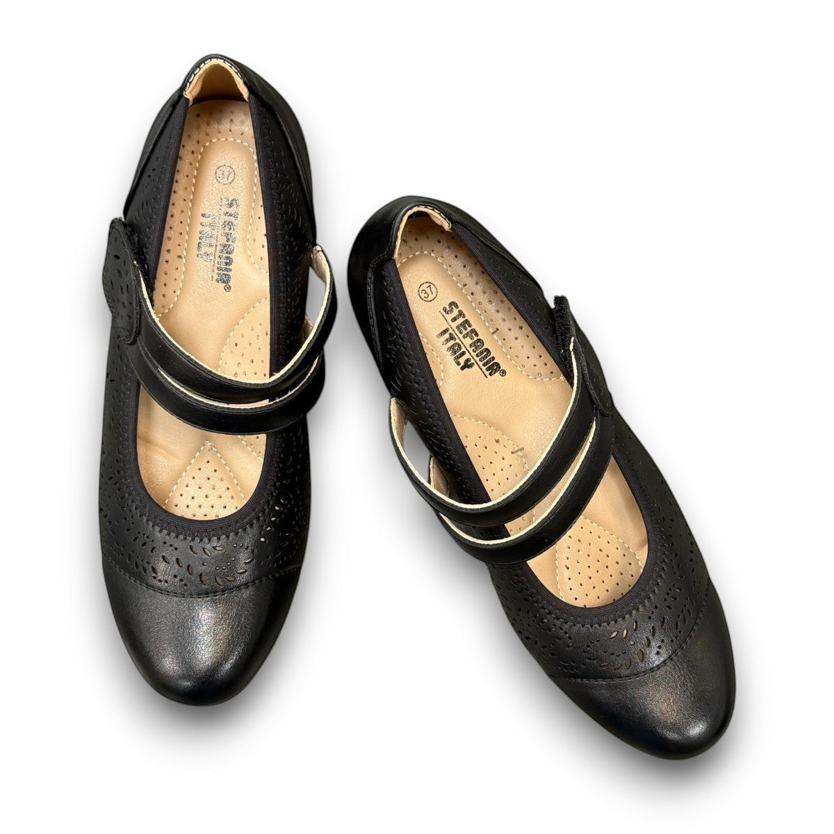 stefania aria black Mary Jane shoe with decorative laser-cut perforations, dual straps, and a stable block heel.
photo of the top side