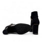 stefania black vegan leather dress booties with block heel, fur lining, and decorative side strap detail.
photo of the bottom side