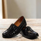 Stefania black croc-embossed slip-on shoe with a low wedge sole and elastic side panel for comfort.
photo of the front side