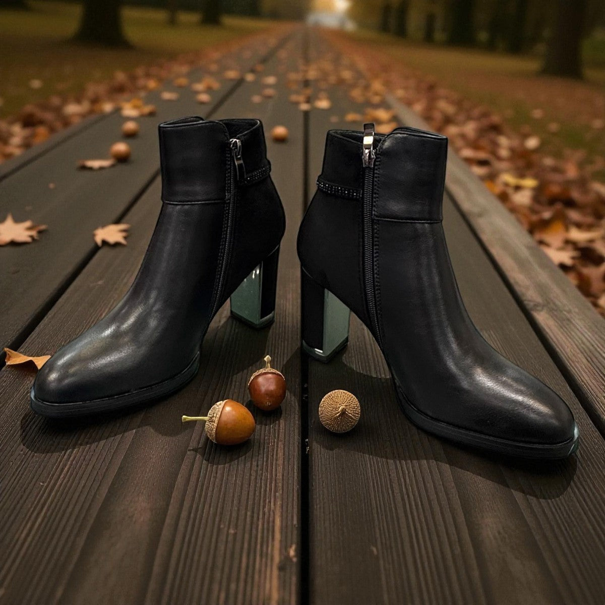 stefania black vegan leather dress booties with block heel, fur lining, and decorative side strap detail.
photo of the front side