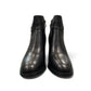 stefania black vegan leather dress booties with block heel, fur lining, and decorative side strap detail.
photo of the front side