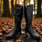 Stefania black vegan leather knee-high boots with fur lining, block heel, and metallic side detail.
photo of the front side