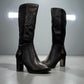 Stefania black vegan leather knee-high boots with fur lining, block heel, and metallic side detail.
photo of the front side
