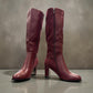 stefania bordo vegan leather knee-high boots with block heel, suede-like panels, and metallic side detail.
photo of the front side