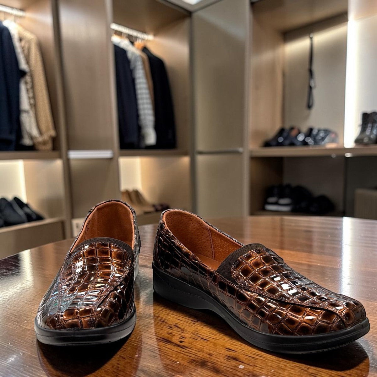 Stefania bronze croc-embossed slip-on shoe with a low wedge sole and elastic side panel.
photo of the front side
